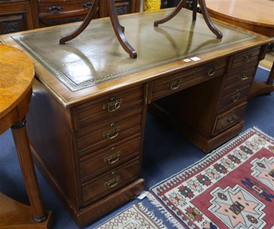 A late Victorian mahogany pedestal desk, fitted nine small drawers, with a green leather inset top, W.137cm